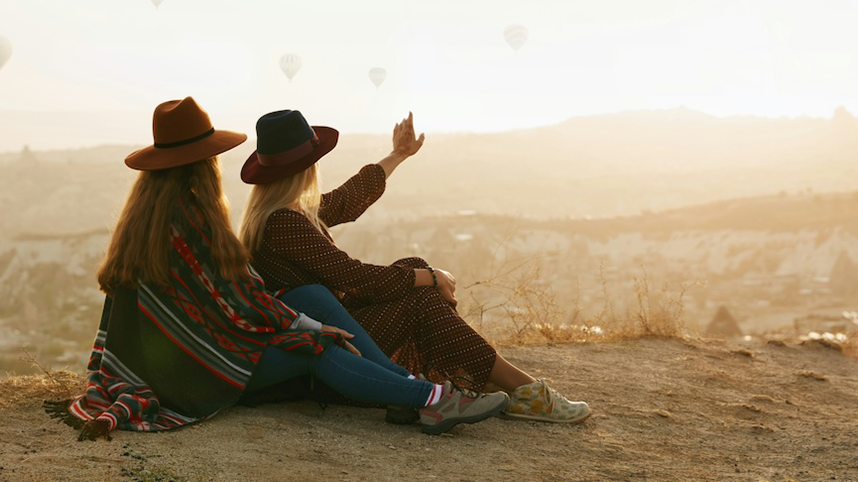 Two People sitting, looking off into distance