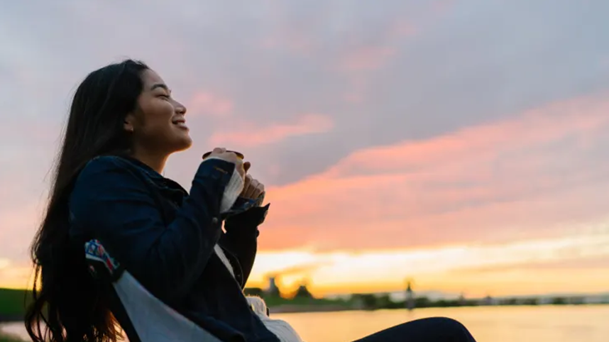 Woman smiling at sunset