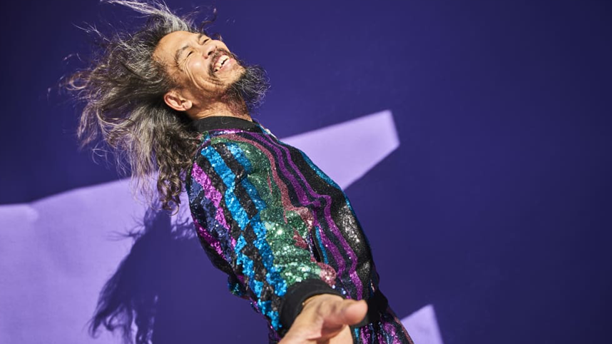 Man smiling on purple background