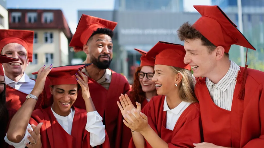 Happy graduates in red robes