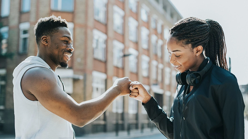 Two People Fist Bumping