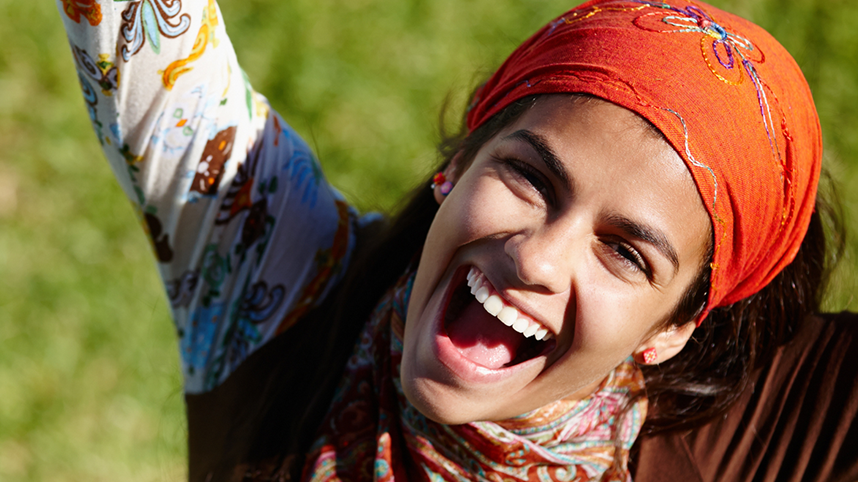 Person looking up, smiling with hands outstretched